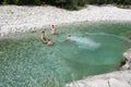 Family spending time together in a crystalclear water of river