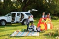 Family spending time together. Girl reading book outdoor Royalty Free Stock Photo