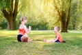 Family parental activity. Young Caucasian mother with child toddler boy doing workout yoga fitness outdoor in park on summer day. Royalty Free Stock Photo