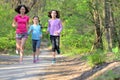 Family sport, happy active mother and kids jogging, running in forest