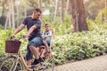 Family sport and healthy lifestyle- father and son riding a bicycle together outdoors in a city park. Royalty Free Stock Photo