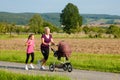 Family sport - jogging with baby stroller Royalty Free Stock Photo