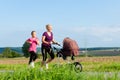 Family sport - jogging with baby stroller Royalty Free Stock Photo