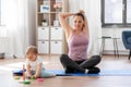 Happy mother with little baby exercising at home Royalty Free Stock Photo