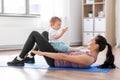 Happy mother with little baby exercising at home