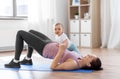 Happy mother with little baby exercising at home Royalty Free Stock Photo