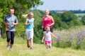 Family sport running through field Royalty Free Stock Photo