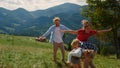 Family spreading hands wings playing outdoor. Couple with children having fun.