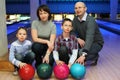 Family of squatting in club for bowling Royalty Free Stock Photo