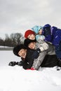 Family stacked in snow. Royalty Free Stock Photo