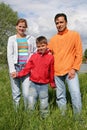 Family stand on grass