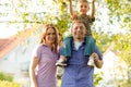 Family standing in front of homes