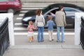 Family standing near pedestrian crossing