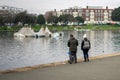 08/04/2019 Portsmouth, Hampshire, UK a family standing next to a lake in winter Royalty Free Stock Photo