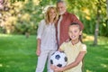 Family standing in the park and looking happy and contented Royalty Free Stock Photo