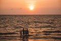 Family standing at sea and watching the sunset. Back view. Silhouette. Thailand, Pattaya 2019-12-24
