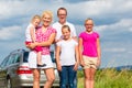 Family standing together in front of car Royalty Free Stock Photo
