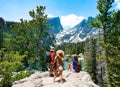 Family standing on top of the mountain enjoying beautiful scenery.