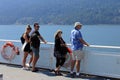 Family standing on the upper deck of a Ferry and enjoying the scenic seascape in Vancouver