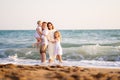 Family stands on shore of sea with high waves. family vacation. trip