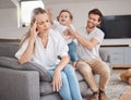 Family, stress and headache of mother on sofa with father, hyper active energy and adhd child. Tired, burnout and woman Royalty Free Stock Photo