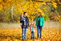 Family strolling in a beautiful autumn park