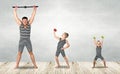 Family of strongman. The father of two sons in vintage costume of athletes perform strength exercises. Family look. Royalty Free Stock Photo
