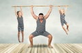 Family of strongman. Father and two sons in vintage costumes drag the rope. Family look.