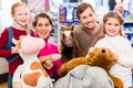 Family with stuffed elephant in toy store playing Royalty Free Stock Photo