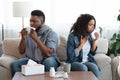 Family Suffering From Coronavirus At Home. Sick Black Couple Coughing On Couch