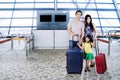 Family with suitcases in the airport terminal Royalty Free Stock Photo