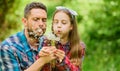 Family summer farm. daughter and father love dandelion flower. little girl and happy man dad. earth day. spring village