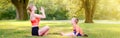 Family summer outdoor sport activity. Mother with child toddler boy doing workout yoga in park. Woman mom doing physical exercises Royalty Free Stock Photo