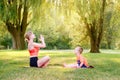 Family summer outdoor sport activity. Young Caucasian mother with child toddler boy doing workout yoga fitness in park. Woman mom Royalty Free Stock Photo