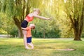 Family summer outdoor sport activity. Young Caucasian mother with child toddler boy doing workout yoga fitness in park. Woman mom Royalty Free Stock Photo