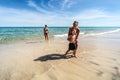 Family summer vacation. Happy mother, father and son running on the beach, playing together and having fun Royalty Free Stock Photo