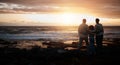 Family, sunset and mockup with people on the beach looking at the view while bonding in nature. Rear view silhouette of Royalty Free Stock Photo