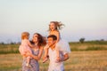 Family at sunset on sloping field countryside