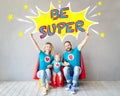 Family of superheroes playing at home Royalty Free Stock Photo