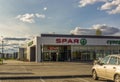 Family supermarket building SPAR in city in summer