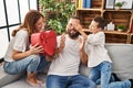 Family surprise father with heart box gift at home