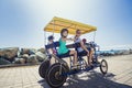 Family on a surrey bike ride along the coast of California Royalty Free Stock Photo