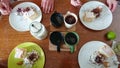 Family sweet breakfast. On the wooden table: custard cake, ice cream in a waffle cone, ice cream sprinkled with chocolate chips,