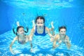 Family swim in pool underwater, happy active mother and children have fun in water, kids sport