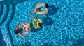 Family in swimming pool aerial drone view from above, happy mother and kids swim on inflatable ring donuts and have fun in water Royalty Free Stock Photo