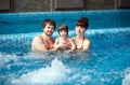 Family swimming in the pool. Happy family spends time and relax in the swimming pool