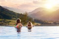 Family in swimming pool with mountain view Royalty Free Stock Photo