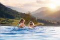 Family in swimming pool with mountain view Royalty Free Stock Photo