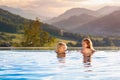 Family in swimming pool with mountain view Royalty Free Stock Photo