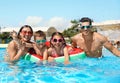 Family in swimming pool. Summer vacation